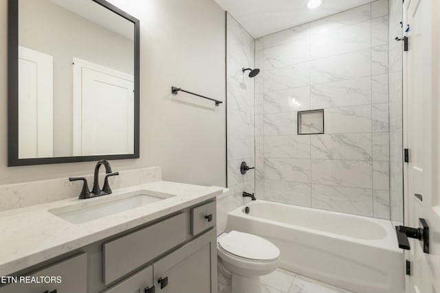 full bathroom with vanity, tiled shower / bath combo, and toilet