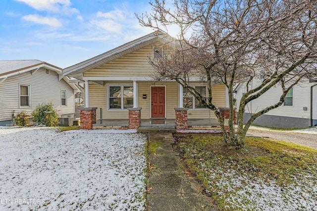 bungalow-style house featuring covered porch and central AC