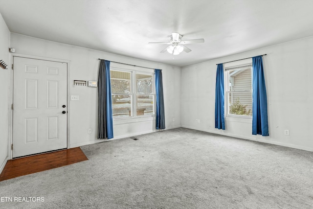 interior space with carpet, a wealth of natural light, and ceiling fan