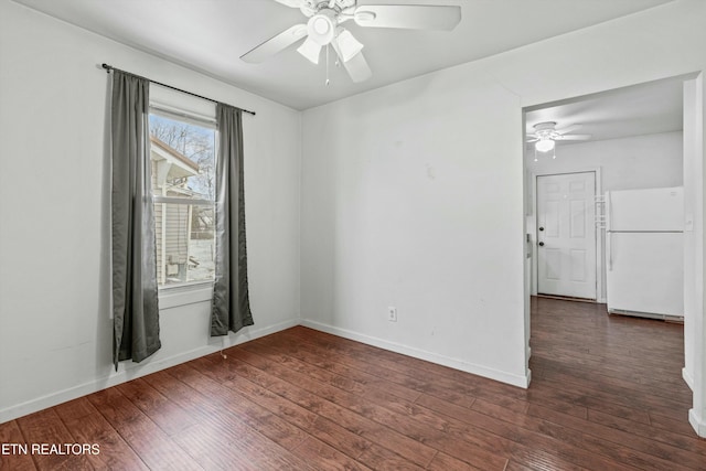 empty room featuring ceiling fan and dark hardwood / wood-style floors