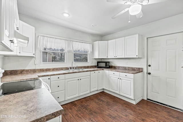 kitchen with ceiling fan, sink, dark hardwood / wood-style flooring, white cabinets, and range