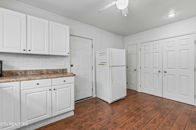 kitchen featuring white fridge, white cabinetry, ceiling fan, and dark wood-type flooring