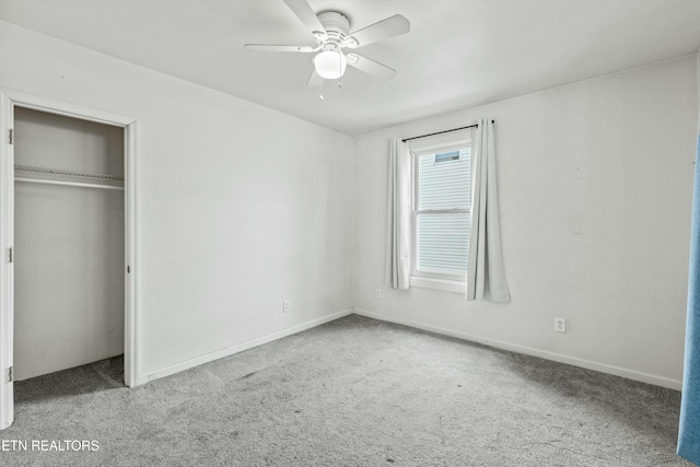 unfurnished bedroom featuring ceiling fan, a closet, and light colored carpet