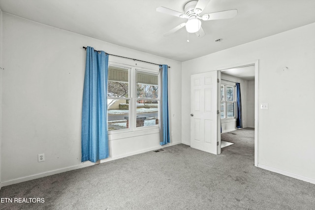 carpeted empty room with ceiling fan