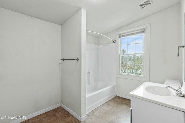 bathroom featuring vanity,  shower combination, and vaulted ceiling