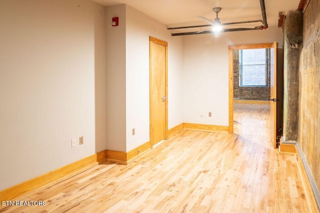 unfurnished room with ceiling fan and light hardwood / wood-style flooring