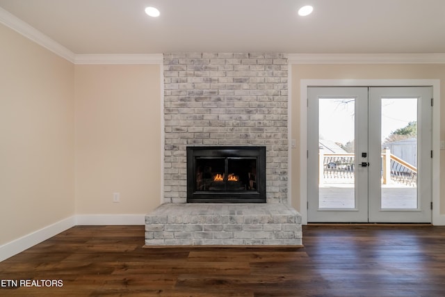 unfurnished living room with a fireplace, french doors, dark hardwood / wood-style floors, and crown molding