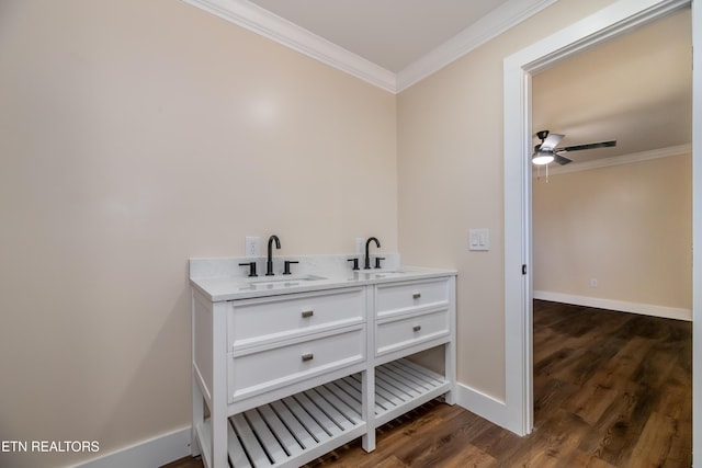 bathroom featuring hardwood / wood-style flooring, vanity, and crown molding