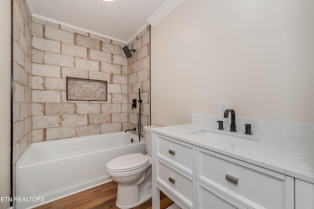 full bathroom featuring crown molding, hardwood / wood-style floors, toilet, vanity, and tiled shower / bath