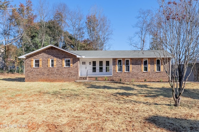 view of front of house with a porch and a front yard