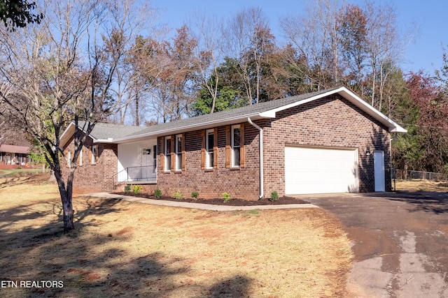 single story home with covered porch and a garage