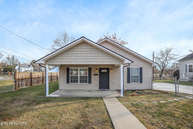 bungalow with covered porch and a front yard