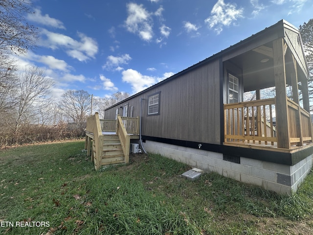 view of side of home with a lawn and a wooden deck