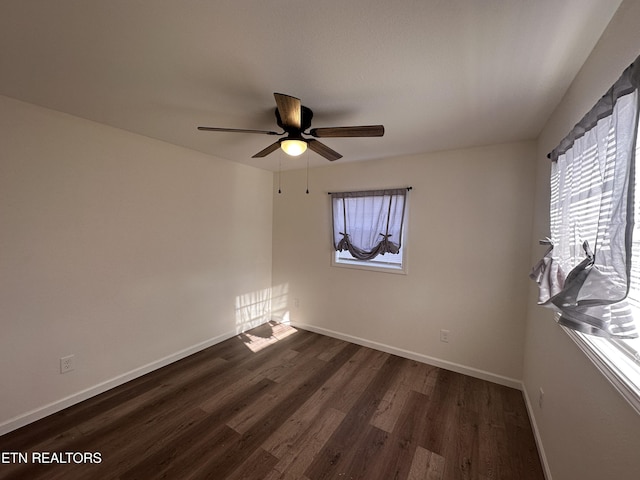 unfurnished room featuring ceiling fan and dark hardwood / wood-style flooring