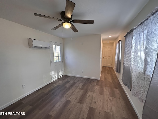 unfurnished room featuring dark hardwood / wood-style floors, a wall mounted AC, and ceiling fan