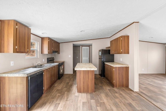 kitchen featuring black appliances, lofted ceiling, a center island, and wood-type flooring