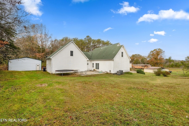 7987 Longmire Rd, Luttrell, TN 37779 - back of property with a patio area, a trampoline, and a yard