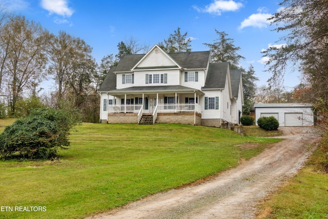 7987 Longmire Rd, Luttrell, TN 37779 - view of front of house featuring an outbuilding, a garage, a front lawn, and covered porch