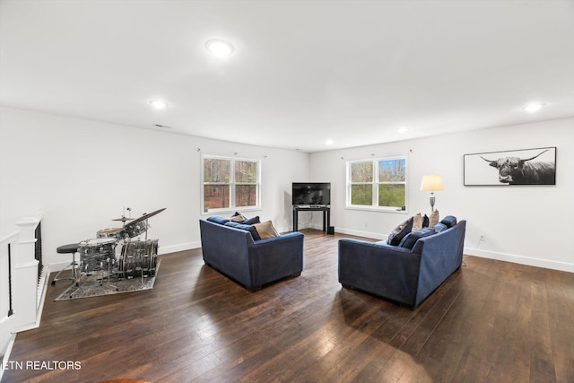 living room featuring dark hardwood / wood-style floors and a healthy amount of sunlight