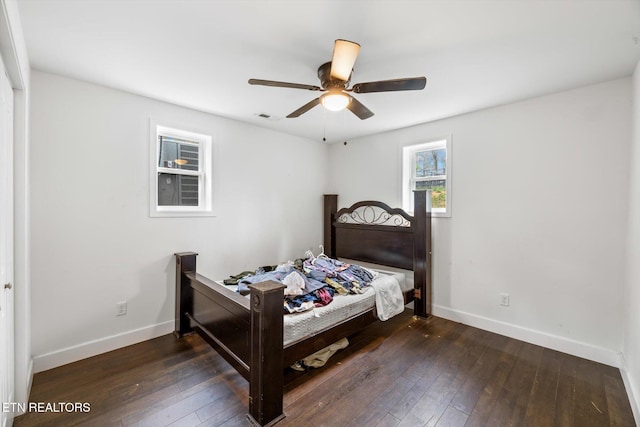 bedroom with ceiling fan and dark hardwood / wood-style floors