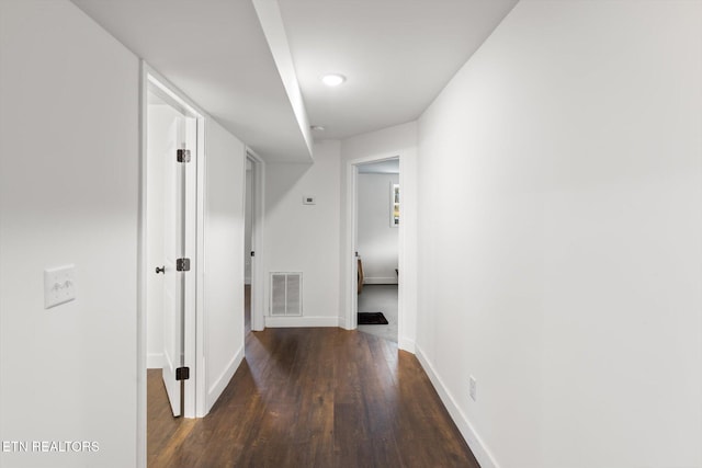 hallway with dark hardwood / wood-style floors