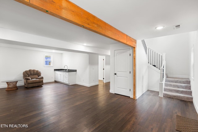 unfurnished living room with dark hardwood / wood-style floors and sink