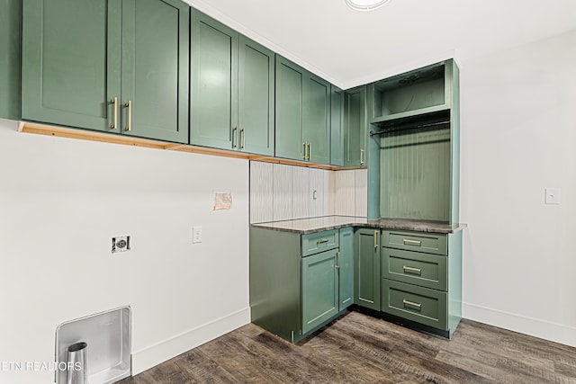 laundry area featuring cabinet space, baseboards, electric dryer hookup, and dark wood finished floors