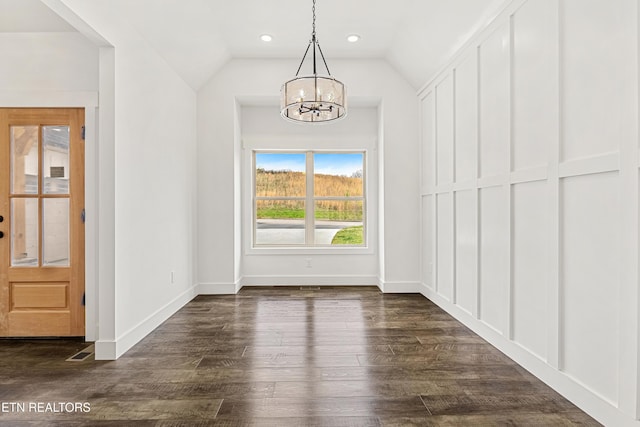 unfurnished dining area featuring lofted ceiling, recessed lighting, dark wood-style flooring, baseboards, and a notable chandelier