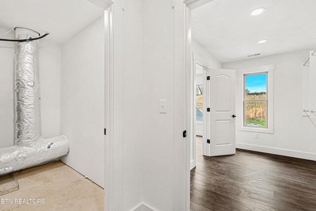 hallway with recessed lighting, baseboards, visible vents, and wood finished floors