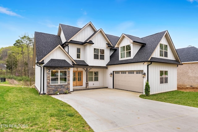 modern farmhouse with a front yard, board and batten siding, concrete driveway, and roof with shingles