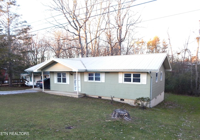 view of front of property with a front yard and a carport