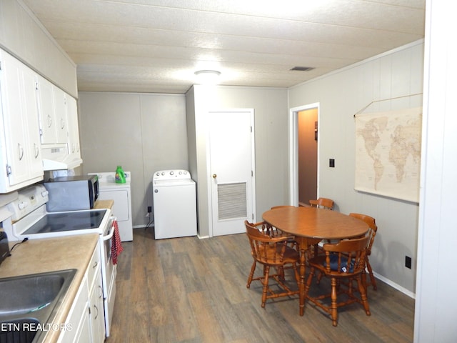 dining area featuring washing machine and dryer, crown molding, sink, and dark wood-type flooring