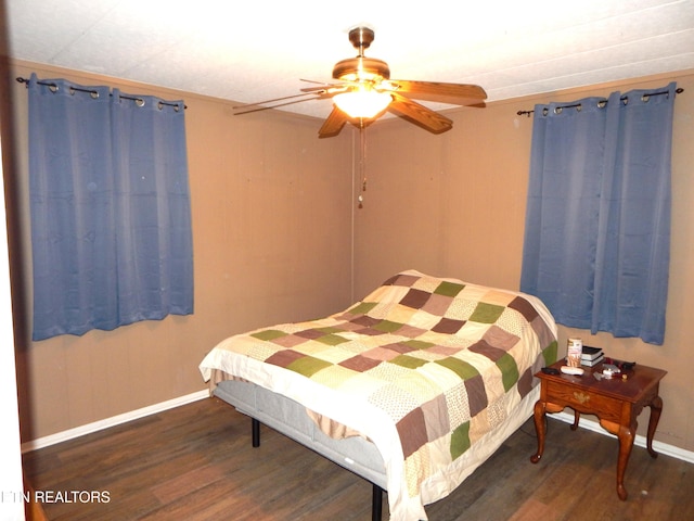 bedroom featuring dark hardwood / wood-style flooring and ceiling fan