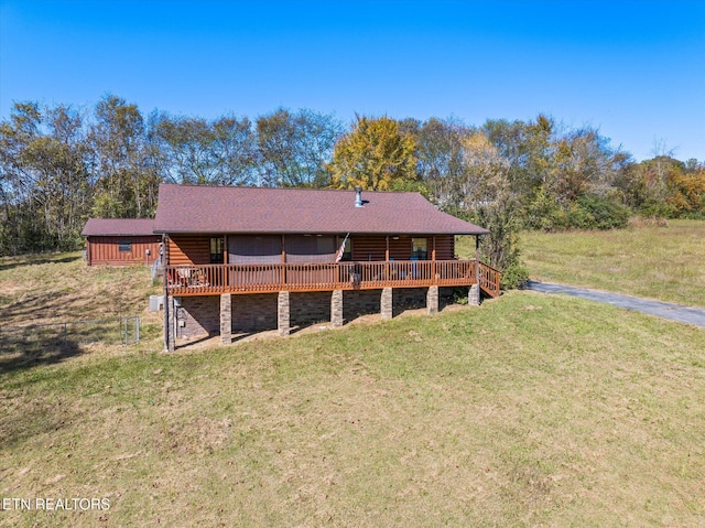 back of property with a lawn and a wooden deck