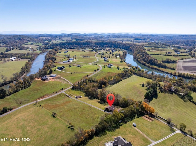 birds eye view of property featuring a water view and a rural view