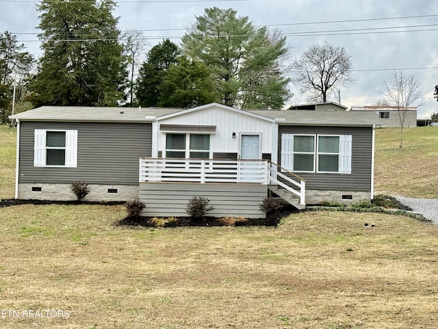 view of front facade featuring a wooden deck and a front lawn