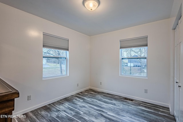 unfurnished room with dark hardwood / wood-style floors