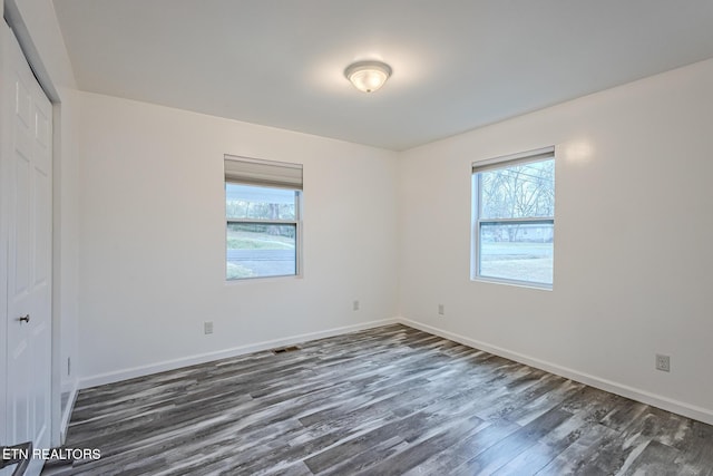 spare room featuring dark hardwood / wood-style floors