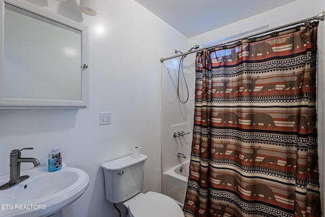 full bathroom with toilet, shower / bathtub combination with curtain, and sink