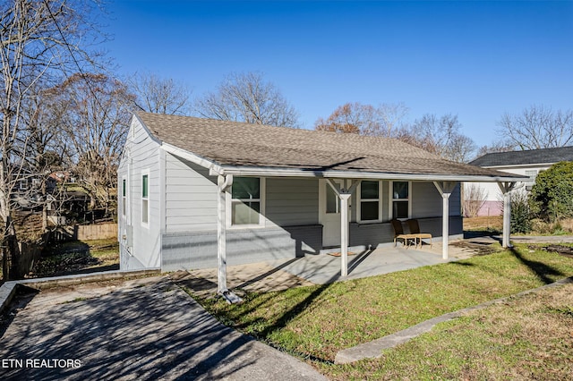 bungalow-style home featuring a patio area and a front yard