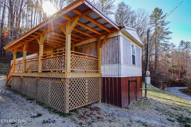 view of property exterior featuring a wooden deck