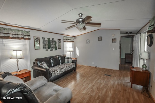 living room with crown molding, ceiling fan, vaulted ceiling, and hardwood / wood-style flooring