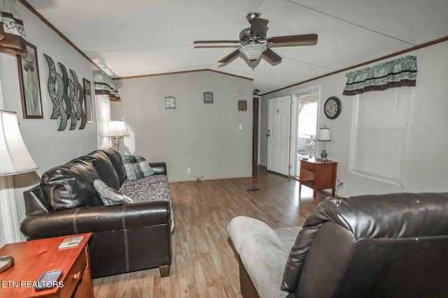 living room featuring vaulted ceiling, light hardwood / wood-style flooring, ceiling fan, and crown molding