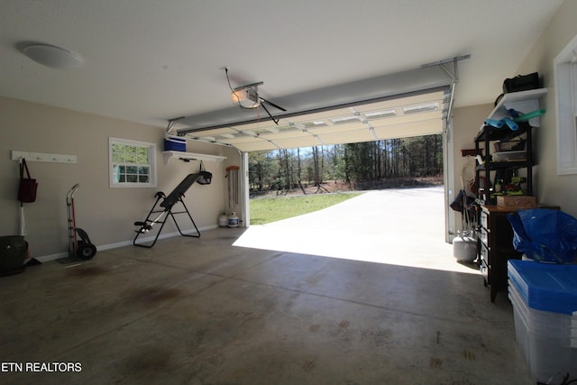 garage with baseboards and a garage door opener