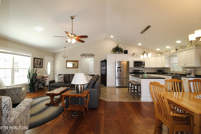 living area featuring lofted ceiling, dark wood-style flooring, ceiling fan, and recessed lighting