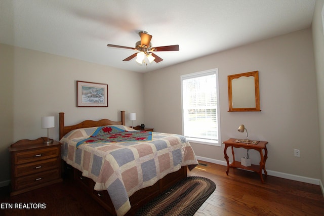 bedroom with dark wood-style floors, visible vents, baseboards, and a ceiling fan