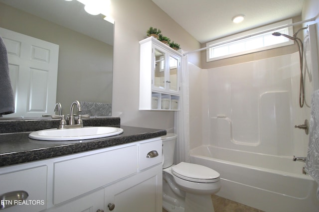 bathroom with shower / bathing tub combination, vanity, and toilet