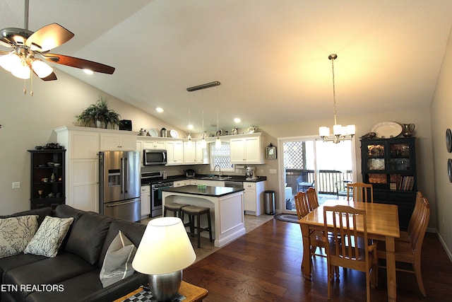 dining room with recessed lighting, ceiling fan with notable chandelier, baseboards, vaulted ceiling, and dark wood finished floors