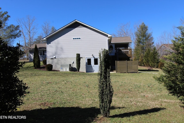 view of side of property featuring central air condition unit and a yard