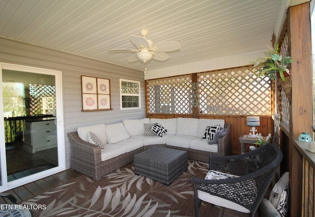 sunroom featuring ceiling fan